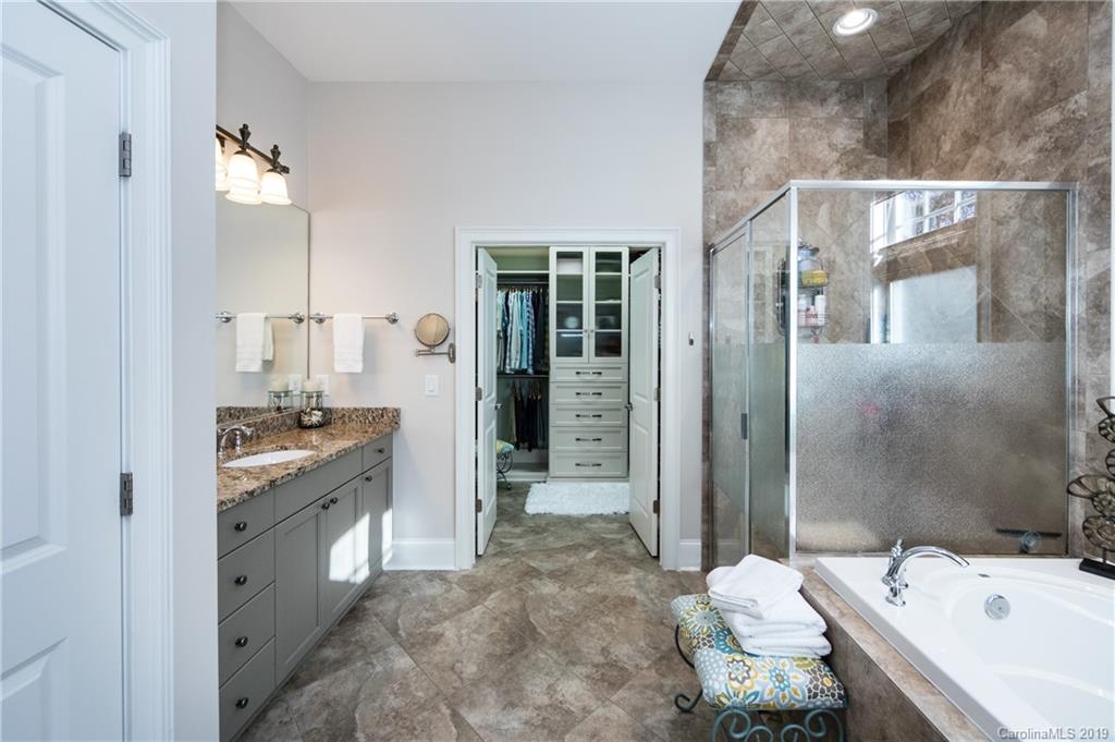 16905 Red Cow Road Charlotte, NC 28277 - Photo 24 of 47 a bathroom with a sink double vanity granite tub shower and mirror
