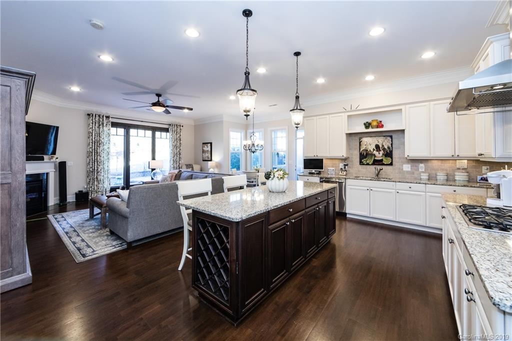 16905 Red Cow Road Charlotte, NC 28277 - Photo 10 of 47 a large kitchen with stainless steel appliances granite countertop a stove a sink dishwasher a refrigerator and a dining table with wooden floor
