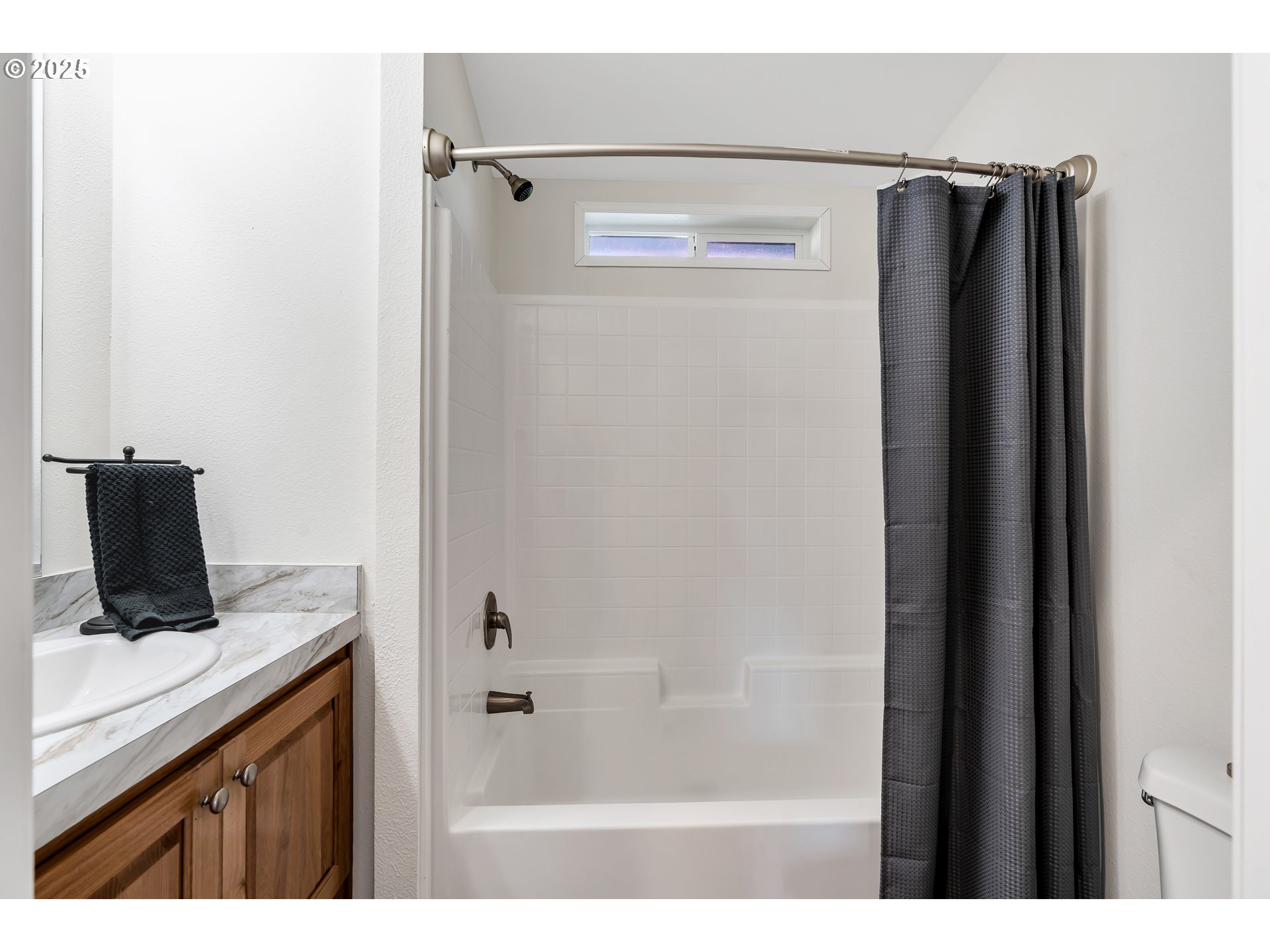 4915 Swegle Road Northeast, Unit 63 Salem, OR 97301 - Photo 15 of 36 a bathroom with a shower curtain and a sink