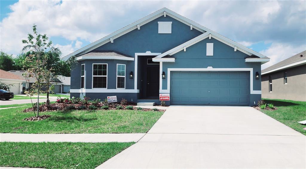 263 Krenson Bay Loop Winter Haven, FL 33881 - Photo 1 of 1 a front view of a house with a yard