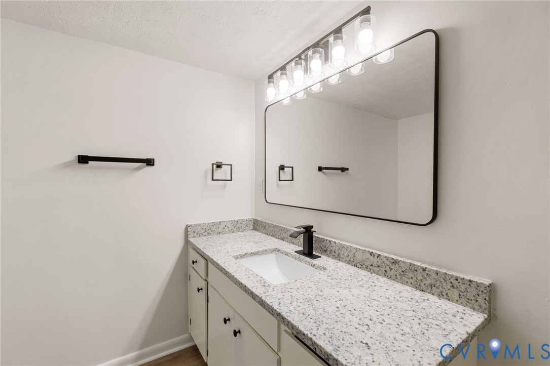1501 Largo Road, Unit 301 Henrico, VA 23238 - Photo 27 of 40 a bathroom with a granite countertop sink and a mirror