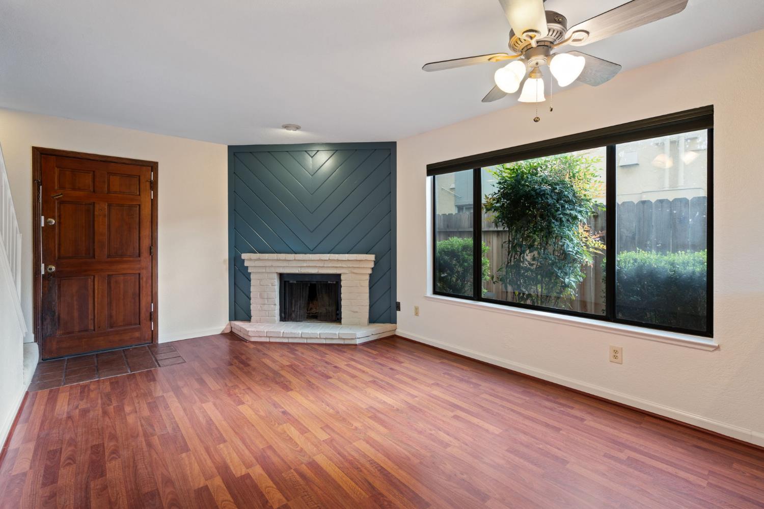2418 P Street, Unit F Sacramento, CA 95816 - Photo 9 of 31 wooden floor fireplace and windows in an empty room