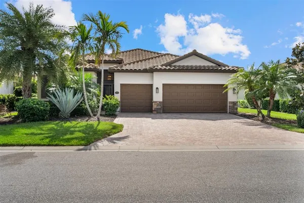 a front view of a house with a yard and garage