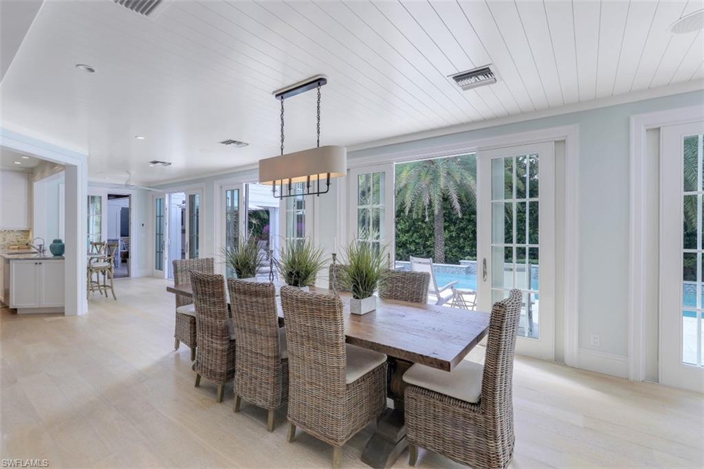 154 4th Avenue North Naples, FL 34102 - Photo 18 of 50 a view of a dining room with furniture window and outside view