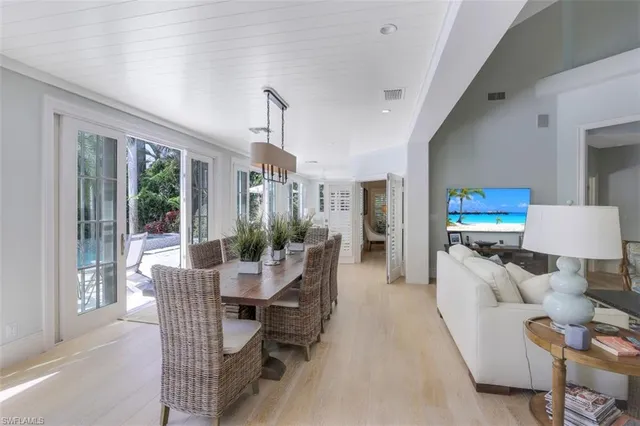 a dining room with furniture and wooden floor