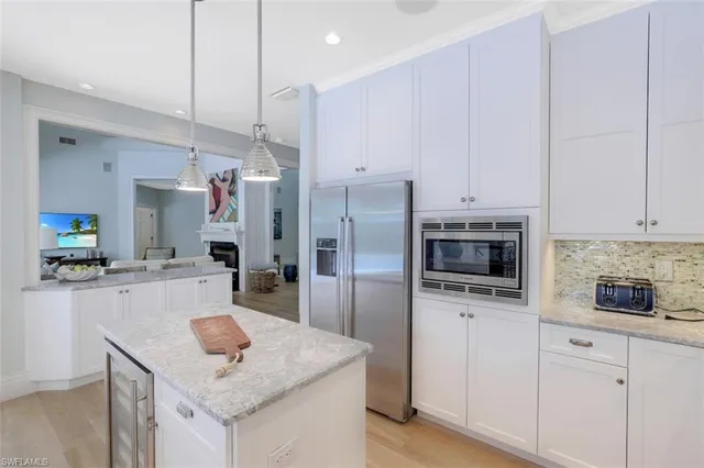 a kitchen with a sink a stove a refrigerator and cabinets