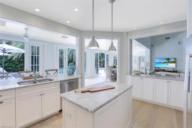 a kitchen with granite countertop white cabinets and white appliances