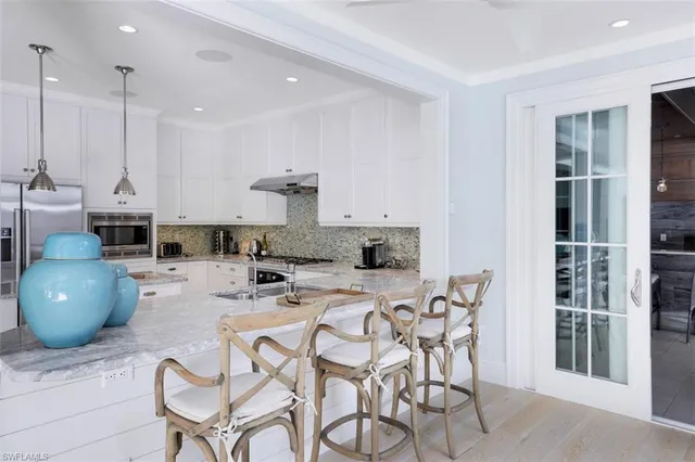 a dining room with furniture and a chandelier