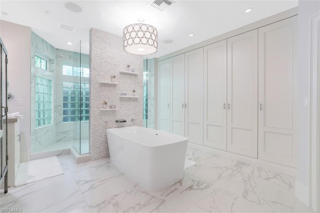 154 4th Avenue North Naples, FL 34102 - Photo 27 of 50 a spacious bathroom with a bathtub and shower