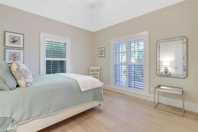 a bedroom with a large bed and a window