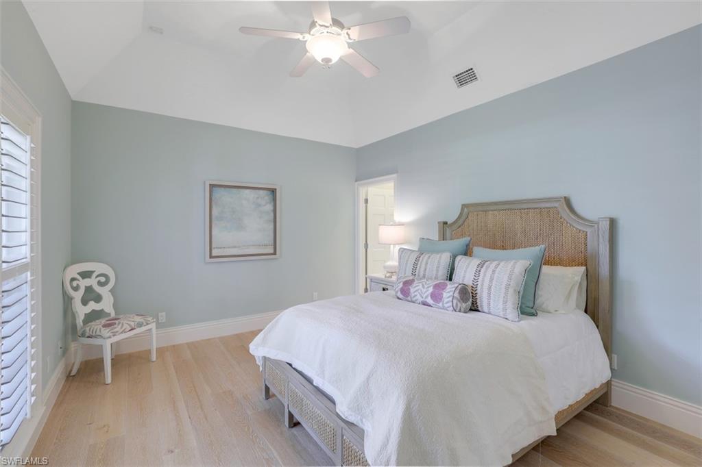 154 4th Avenue North Naples, FL 34102 - Photo 31 of 50 a bedroom with a bed and a chair