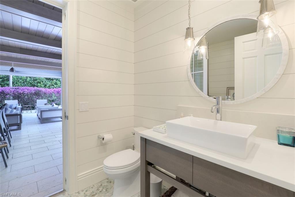 154 4th Avenue North Naples, FL 34102 - Photo 33 of 50 a bathroom with a sink a toilet and shower