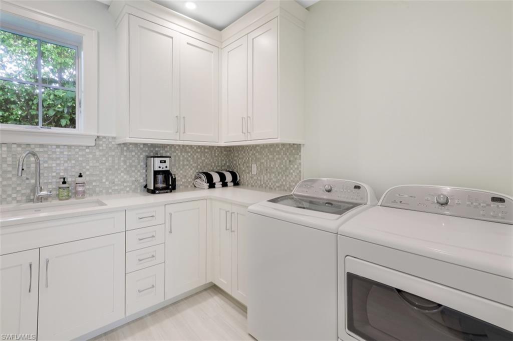 154 4th Avenue North Naples, FL 34102 - Photo 34 of 50 a view of storage and utility room with washer and dryer