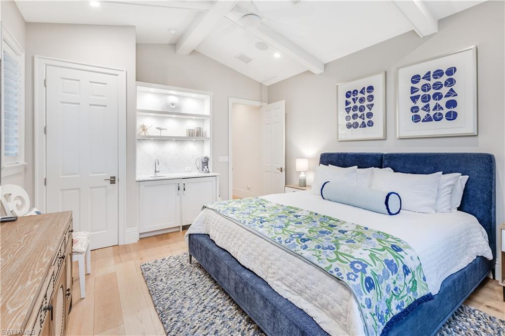 154 4th Avenue North Naples, FL 34102 - Photo 35 of 50 a bedroom with a large bed and a rug