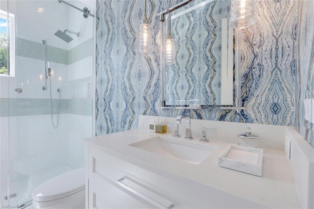 154 4th Avenue North Naples, FL 34102 - Photo 37 of 50 a bathroom with a bathtub and a sink