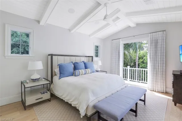 a bedroom with a bed a table and chair