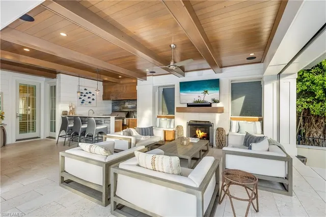a living room with furniture fireplace and a large window