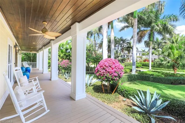 a front view of a house with a porch and furniture
