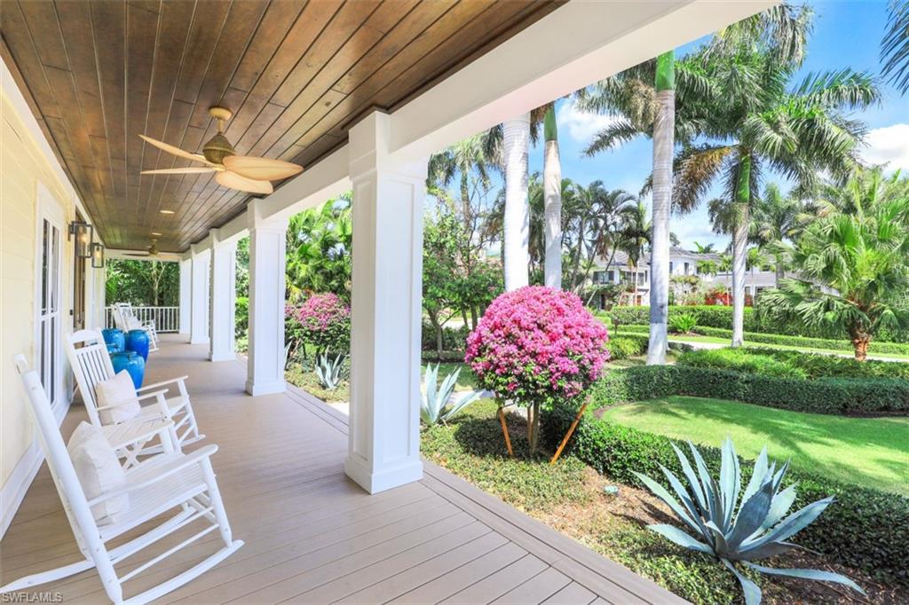 154 4th Avenue North Naples, FL 34102 - Photo 5 of 50 a front view of a house with a porch and furniture