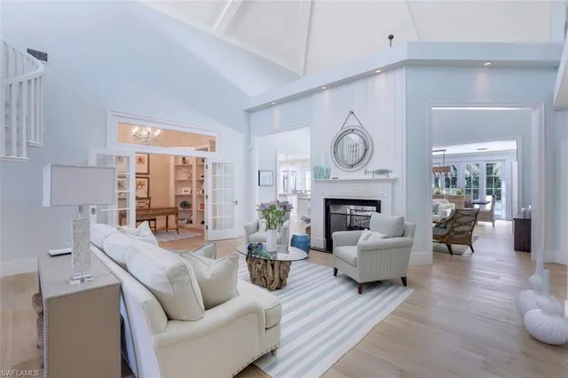 a living room with furniture a fireplace and a chandelier