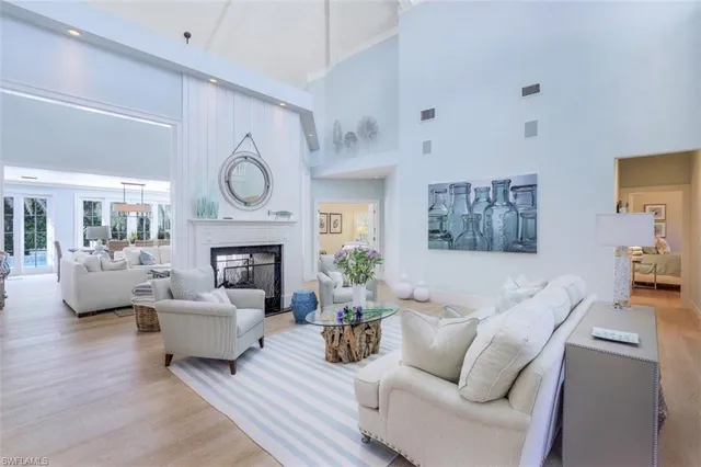 a living room with furniture a fireplace and a large window