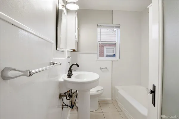 a bathroom with a sink a toilet and bathtub