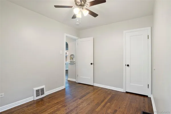 a view of an empty room with wooden floor