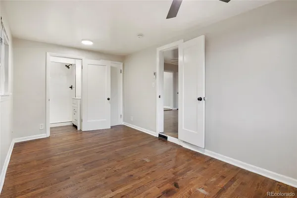 a view of empty room with wooden floor