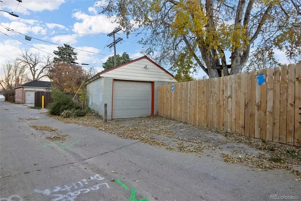 a white house that has tree in front of it