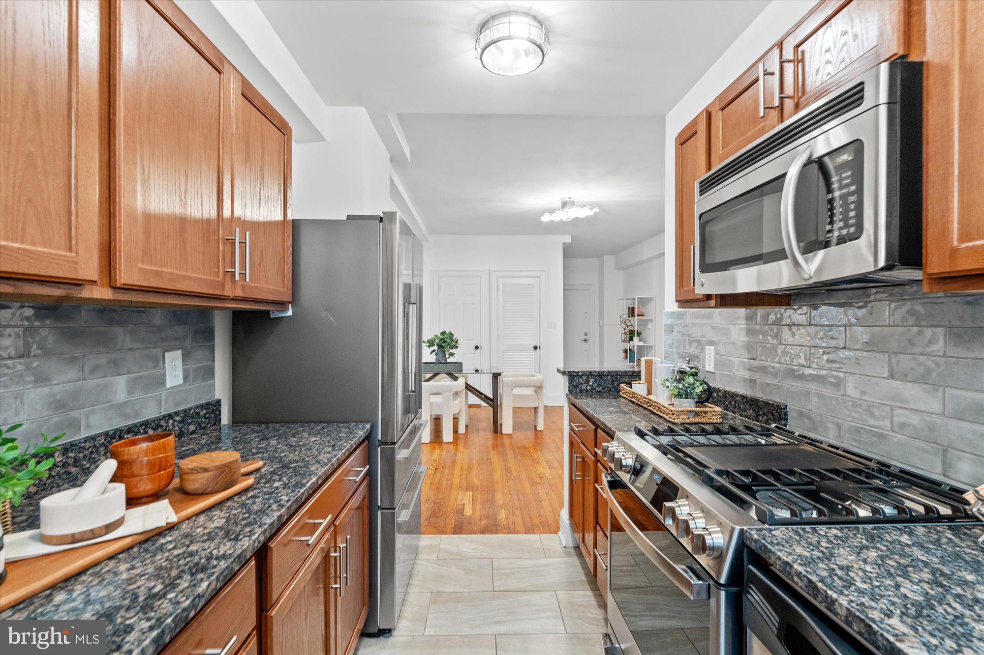 1910 Kalorama Road Northwest, Unit 203 Washington, DC 20009 - Photo 14 of 28 Stainless steel appliances and custom backsplash