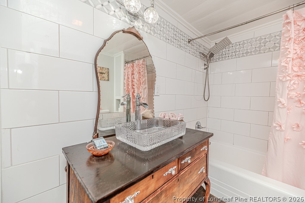 509 Carthage Street Cameron, NC 28326 - Photo 16 of 43 a bathroom with a sink and a mirror
