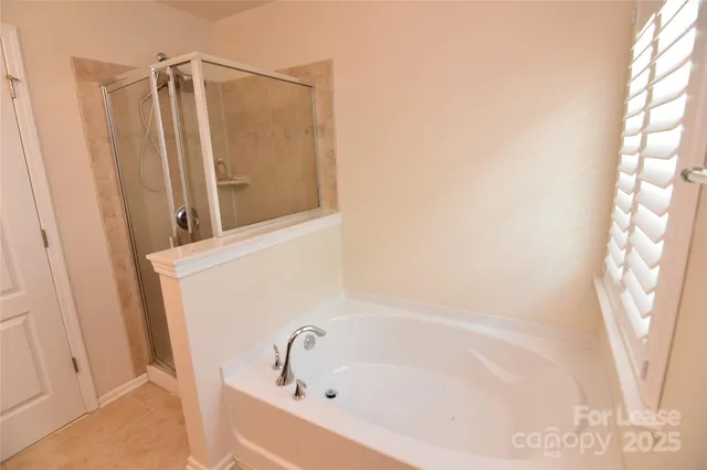 a bathroom with bathtub and shower