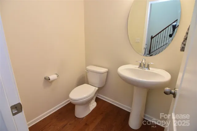 a bathroom with a sink toilet and a mirror
