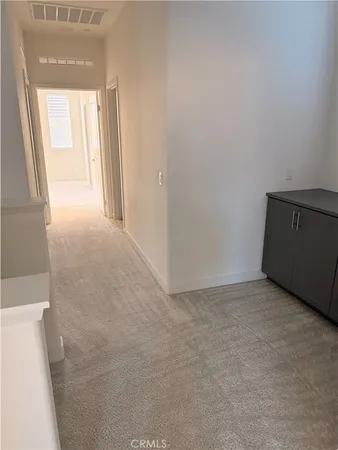 a view of an empty room and a window