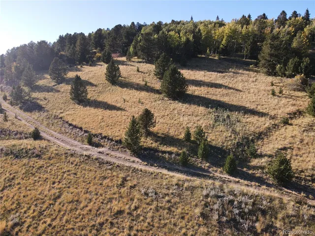 an aerial view of mountain with wooden fence