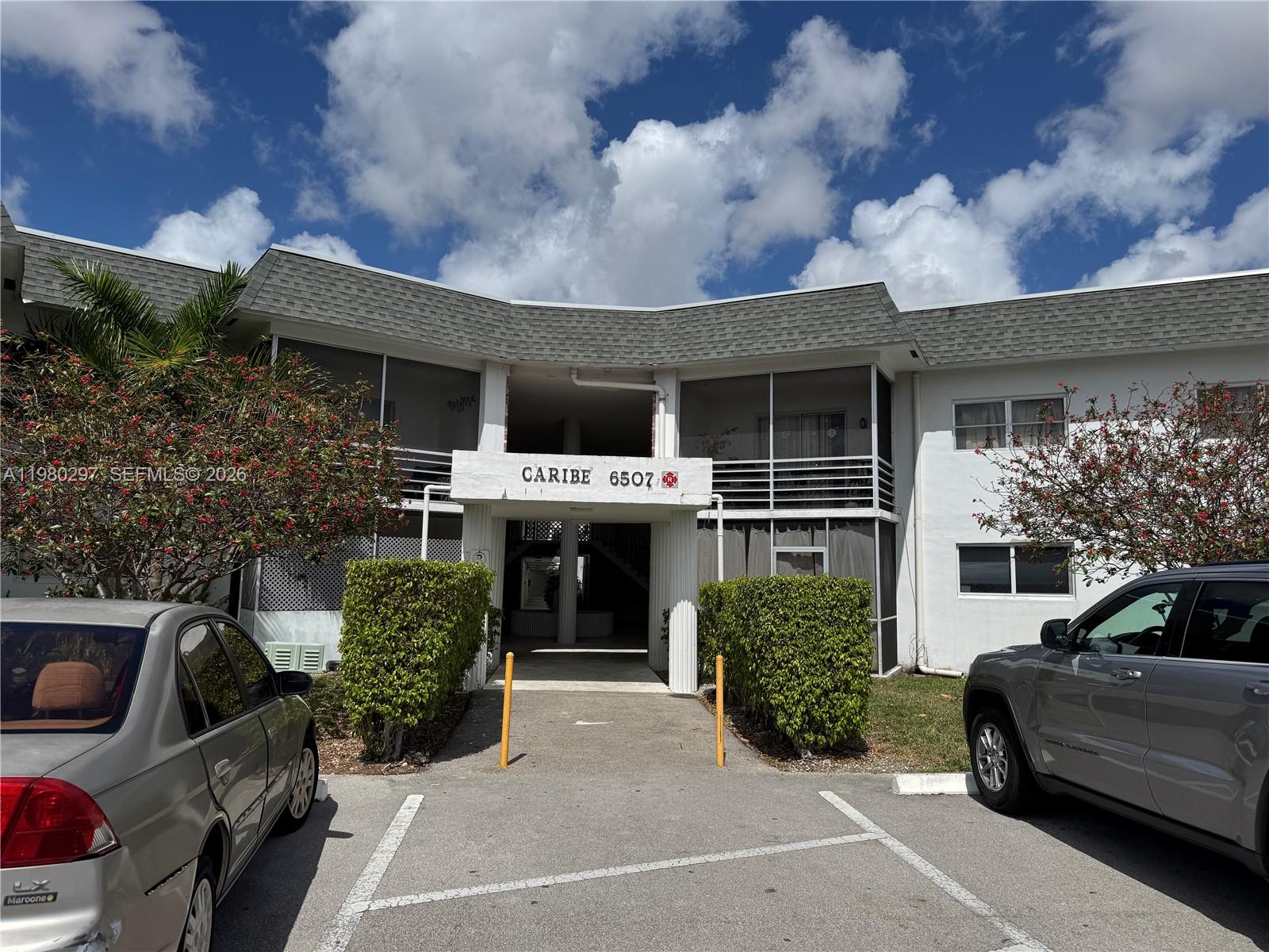 6507 Winfield Boulevard, Unit 111AC Margate, FL 33063 - Photo 1 of 42 a front view of a house with garden