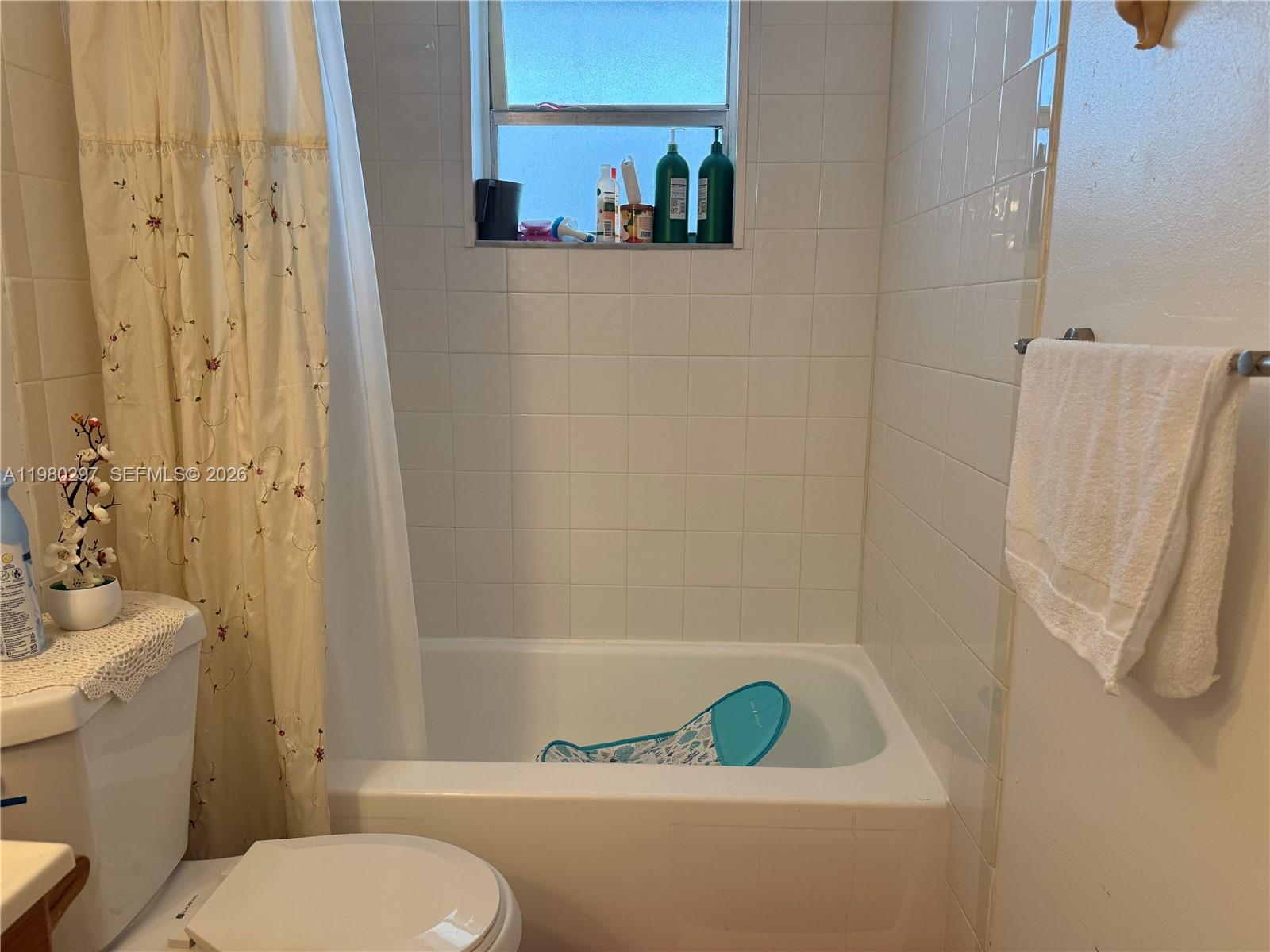 6507 Winfield Boulevard, Unit 111AC Margate, FL 33063 - Photo 22 of 42 a bathroom with a sink and a toilet