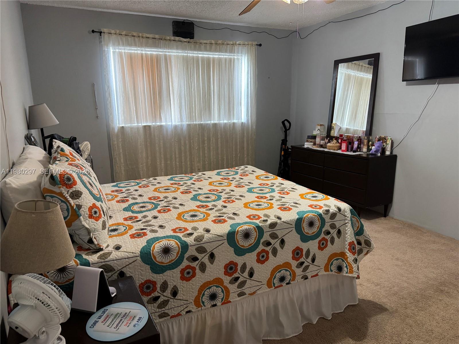 6507 Winfield Boulevard, Unit 111AC Margate, FL 33063 - Photo 24 of 42 a bedroom with a bed and a window