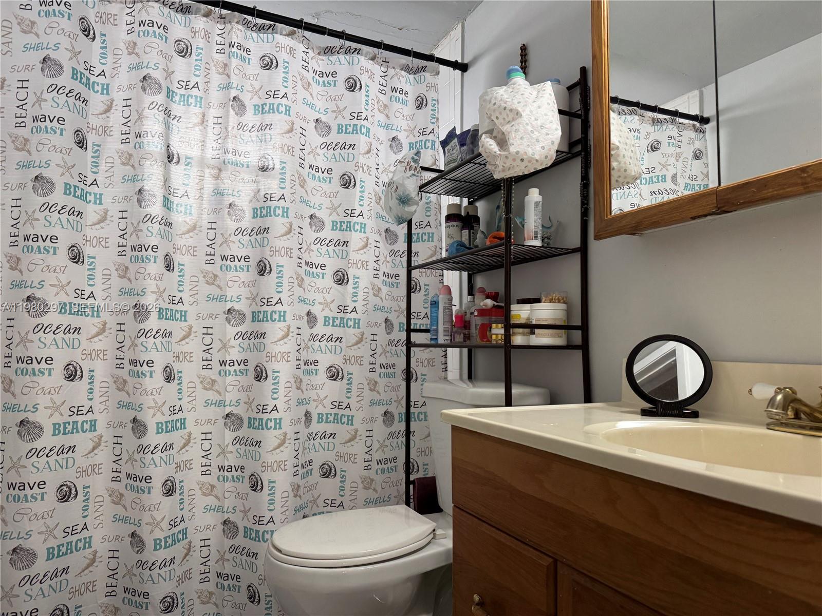 6507 Winfield Boulevard, Unit 111AC Margate, FL 33063 - Photo 27 of 42 a bathroom with a toilet and a sink