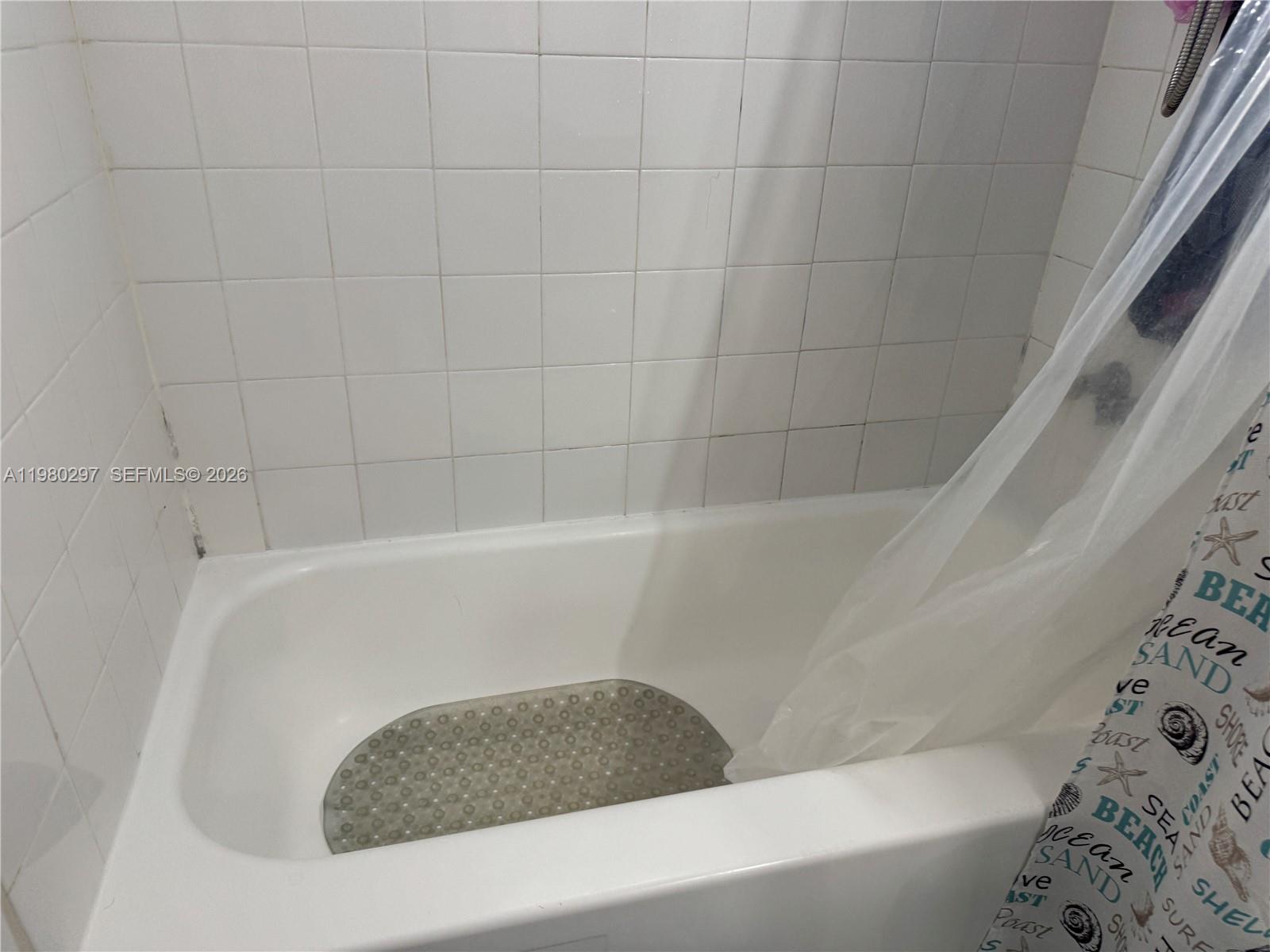 6507 Winfield Boulevard, Unit 111AC Margate, FL 33063 - Photo 28 of 42 a bathroom with a bathtub