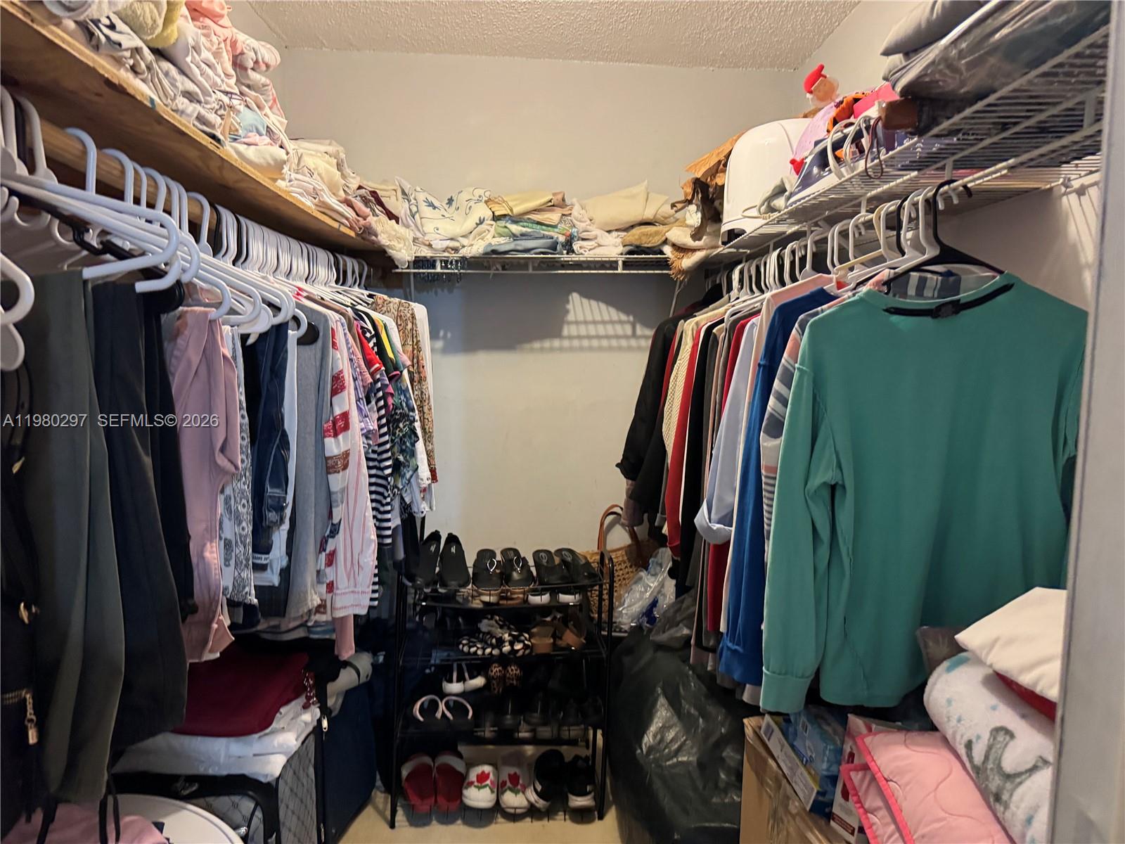 6507 Winfield Boulevard, Unit 111AC Margate, FL 33063 - Photo 31 of 42 a view of walk in closet with clothes and shoes