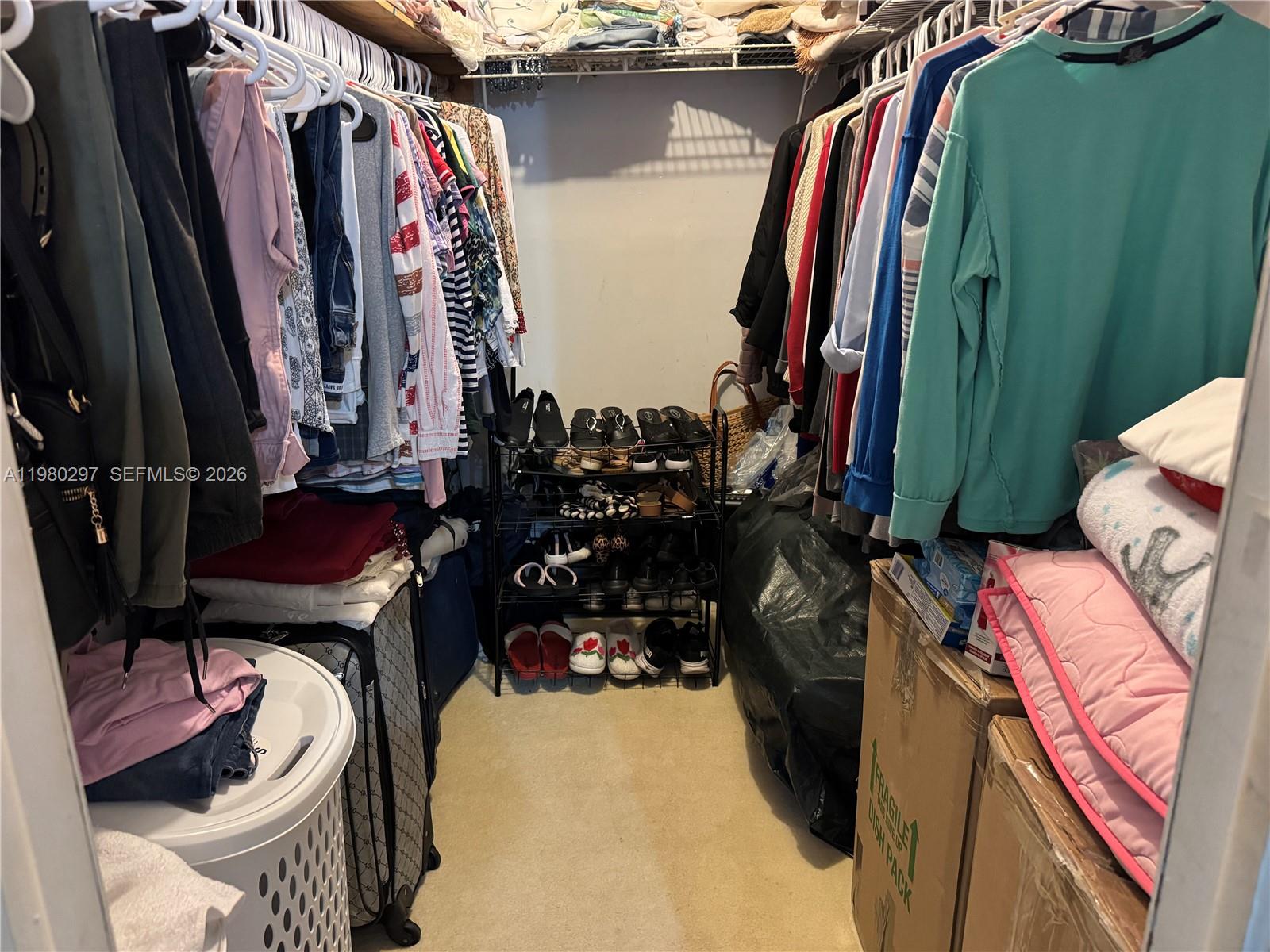 6507 Winfield Boulevard, Unit 111AC Margate, FL 33063 - Photo 32 of 42 a view of walk in closet with clothes and shoes