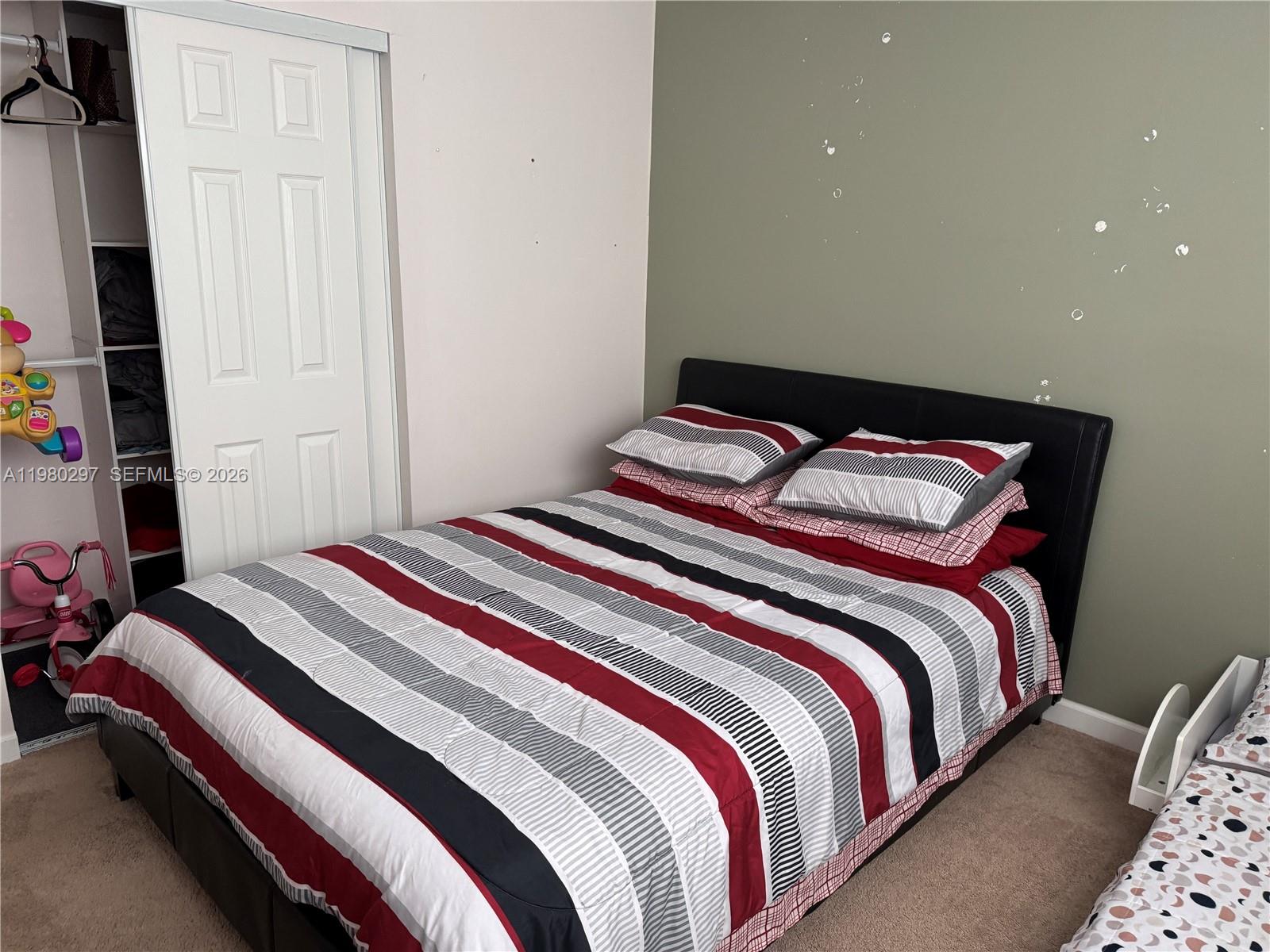 6507 Winfield Boulevard, Unit 111AC Margate, FL 33063 - Photo 39 of 42 a bedroom with bed and a window