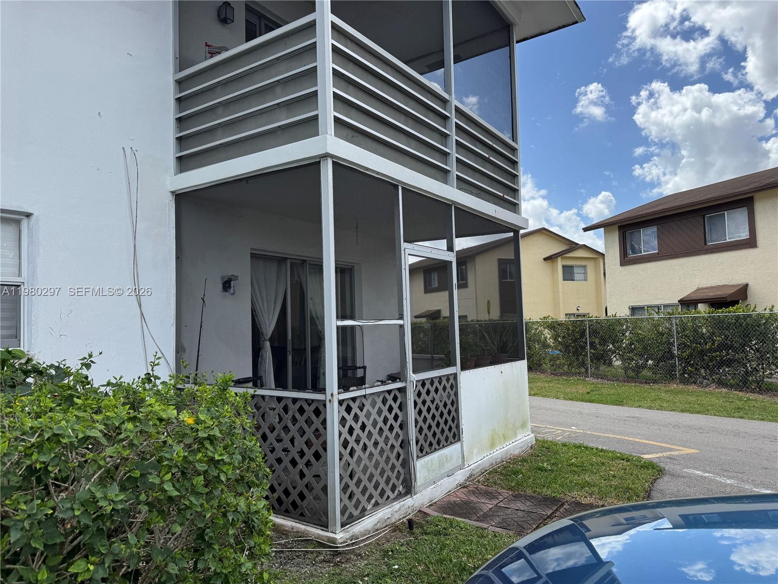 6507 Winfield Boulevard, Unit 111AC Margate, FL 33063 - Photo 42 of 42 a view of a house with a small yard and wooden floor