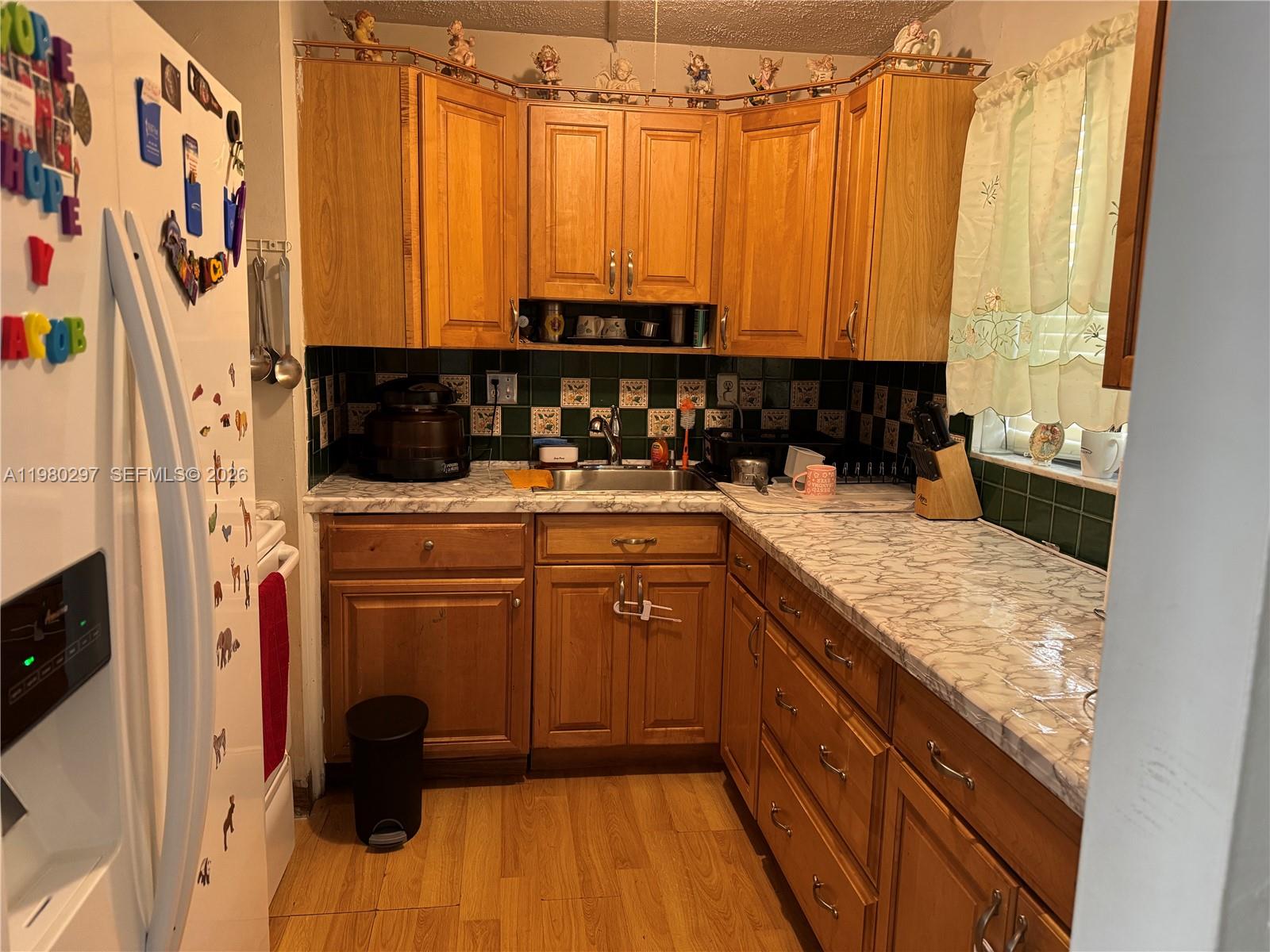 6507 Winfield Boulevard, Unit 111AC Margate, FL 33063 - Photo 6 of 42 a kitchen with stainless steel appliances granite countertop a sink and a counter space