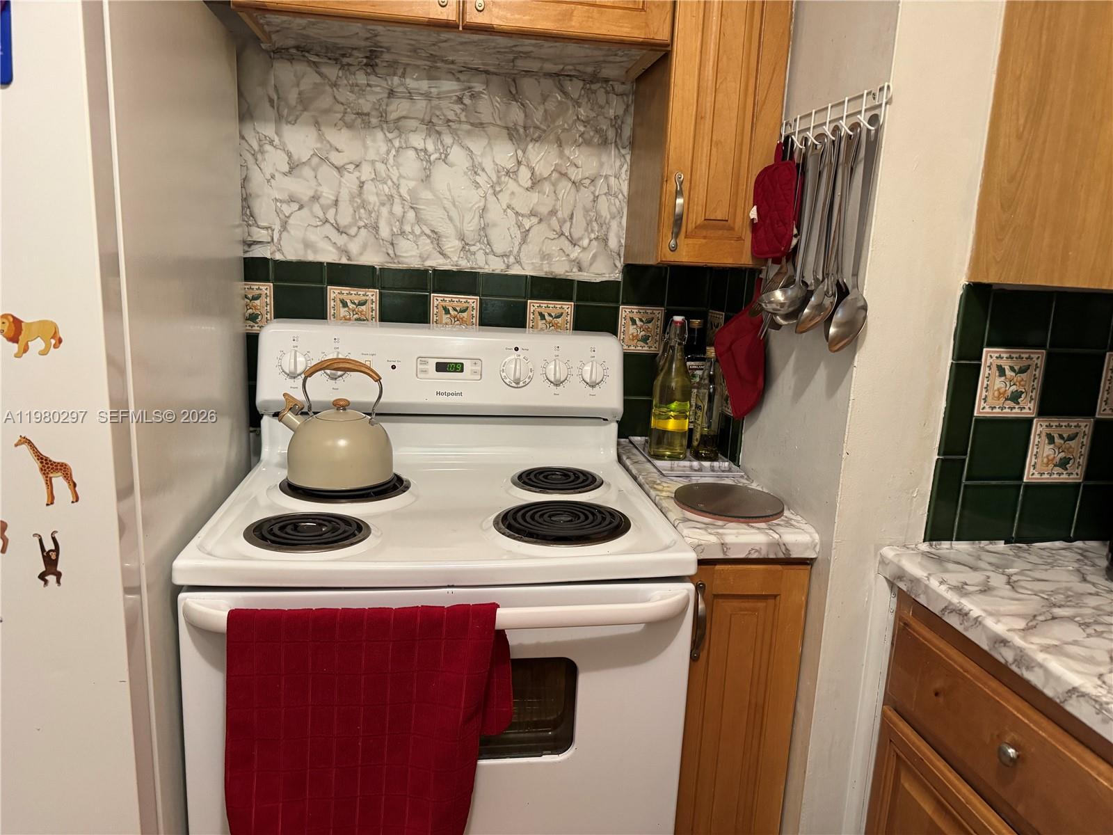 6507 Winfield Boulevard, Unit 111AC Margate, FL 33063 - Photo 7 of 42 a sink and a stove top oven sitting inside of a kitchen