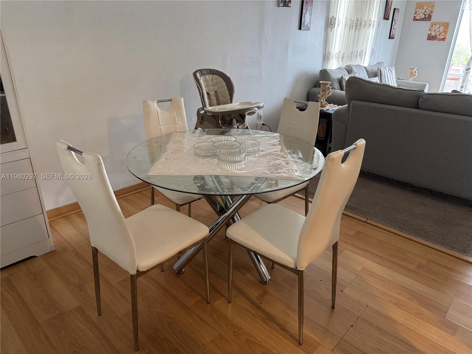 6507 Winfield Boulevard, Unit 111AC Margate, FL 33063 - Photo 10 of 42 a view of a dining room with furniture and wooden floor