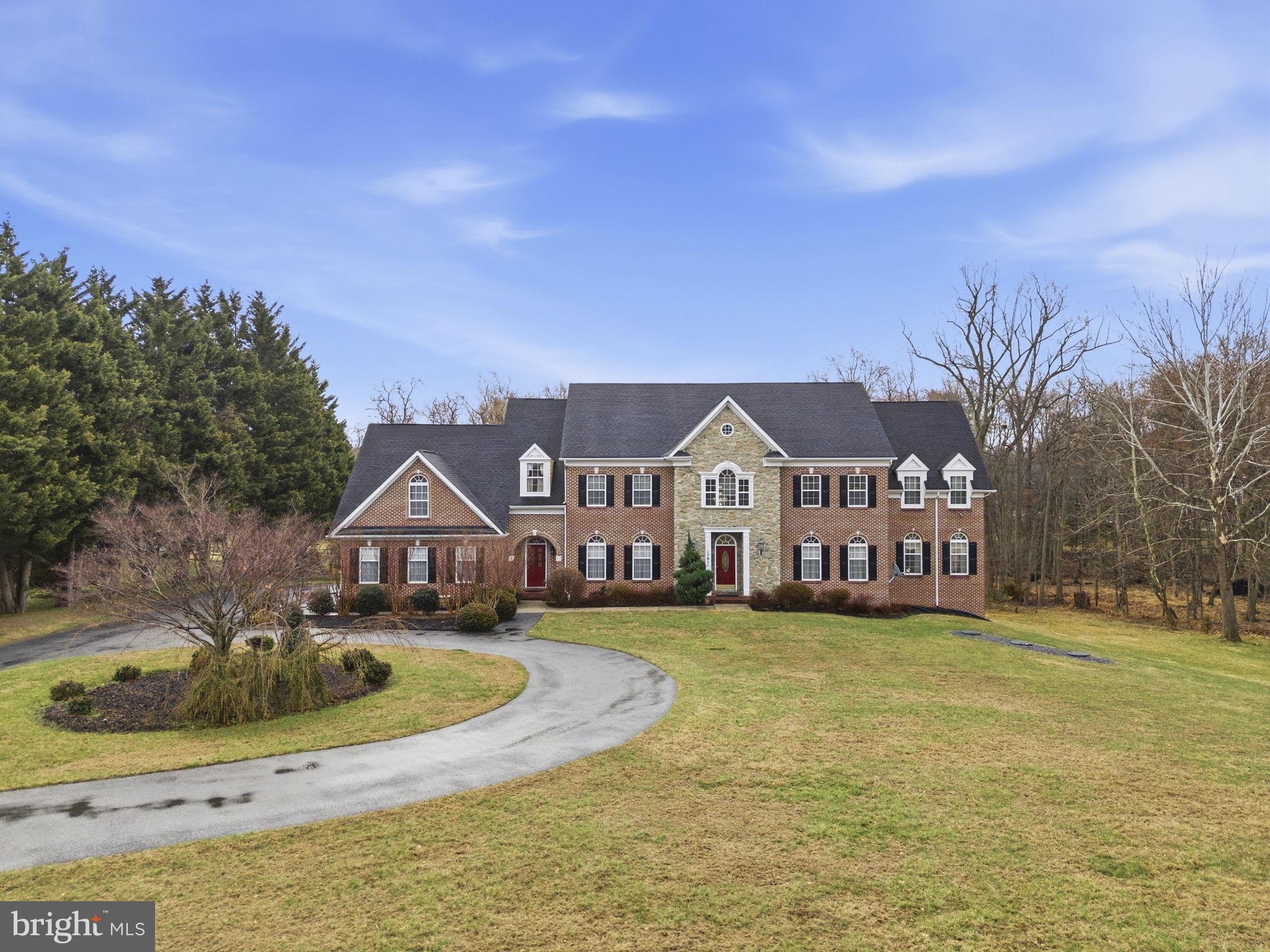 Welcome to this elegant brick colonial!