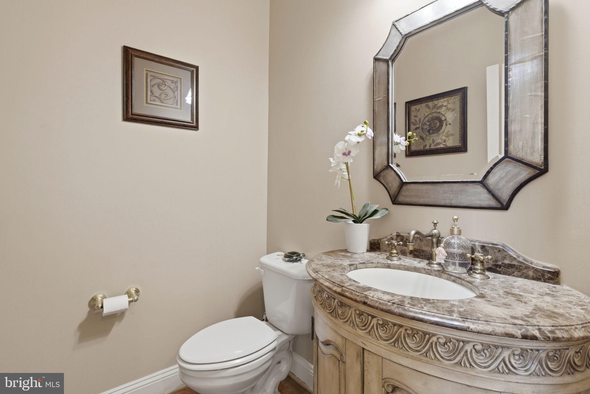 15611 Riding Stable Road Laurel, MD 20707 - Photo 39 of 86 a bathroom with a granite countertop toilet a sink and mirror