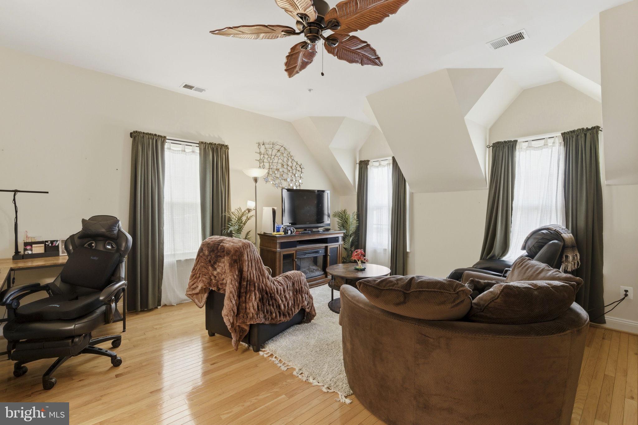 15611 Riding Stable Road Laurel, MD 20707 - Photo 49 of 86 a living room with furniture and a flat screen tv